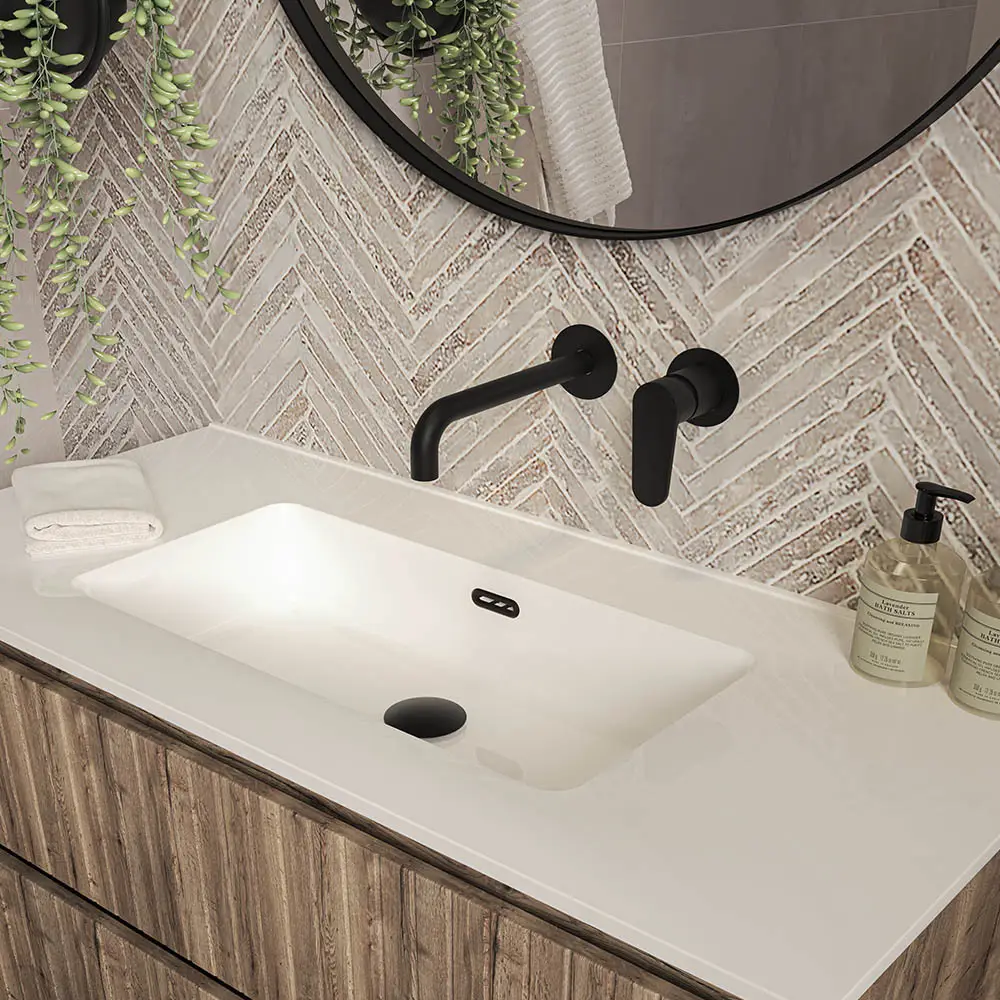 a sink with a round mirror above it