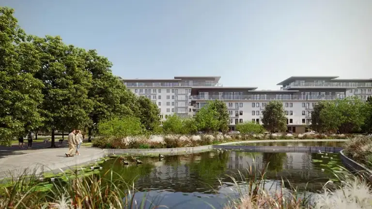 a building with trees and a pond